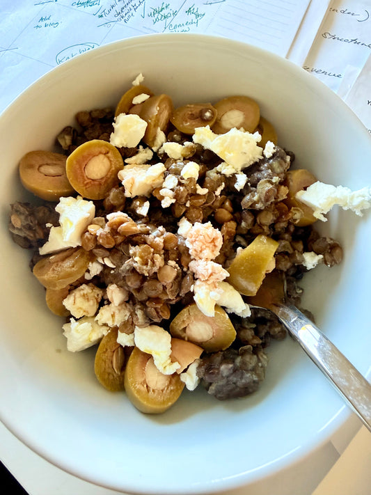Close-up of a nutrient-dense Mediterranean lentil salad dressed with high-quality organic Greek EVOO.